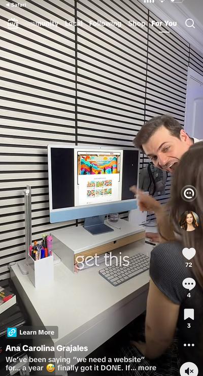 Ana and friend looking at colorful art website on iMac