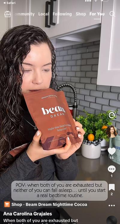 Ana holding Beam Dream nighttime cocoa pouch in kitchen