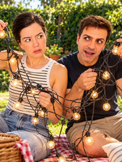 Couple tangled in string lights at picnic — comedy sketch