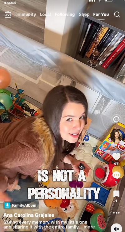 Ana looking down at Gordie the dog surrounded by toys