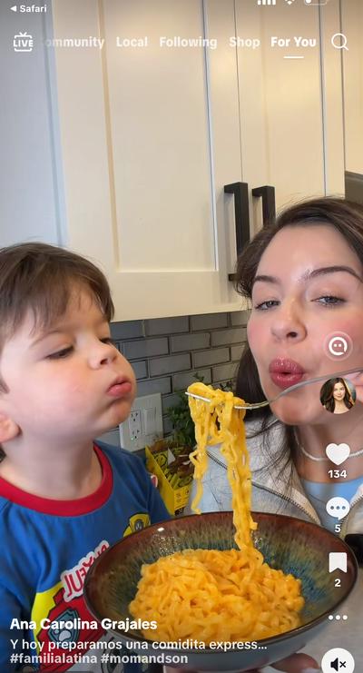 Ana and Mateo eating noodles together in the kitchen