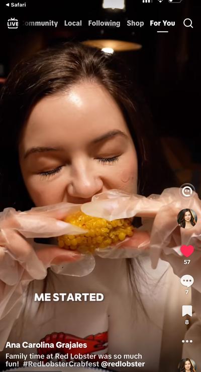 Ana eating crab at Red Lobster Crabfest with gloves on