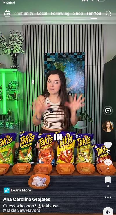 Ana with 6 Takis flavor bags lined up on table